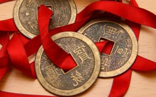 Chinese coins, strung on red ribbon